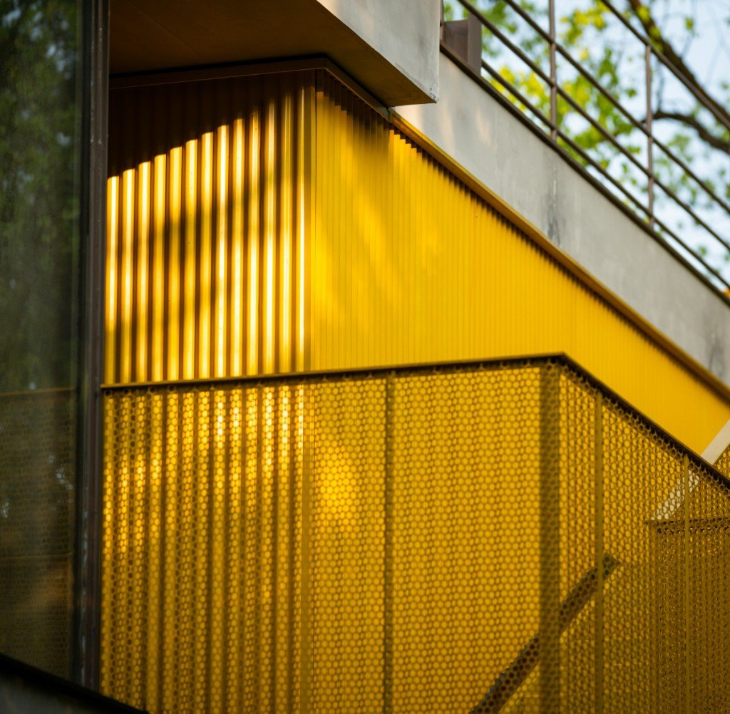 Architectural metal screen and glass at golden hour