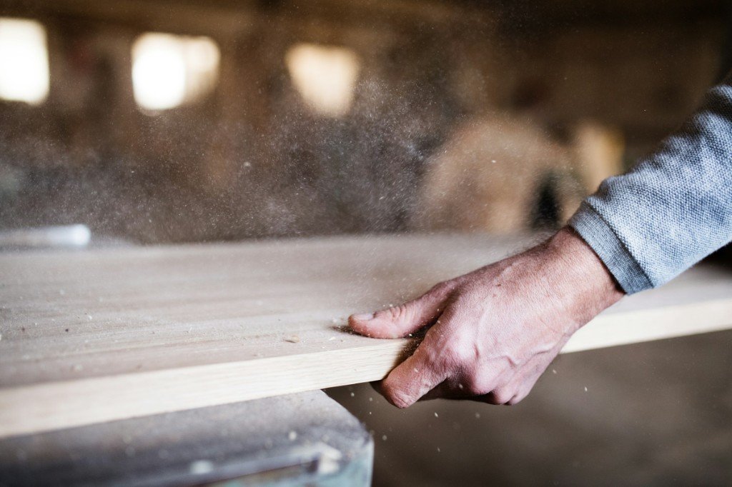 Hand planing oak timber on a workbench